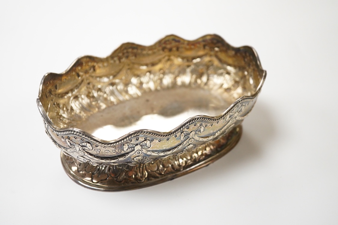A late Victorian embossed silver oval bowl, by Charles Stuart Harris, with engraved initials to the base, London, 1890, length 16.4cm, 7.3oz.